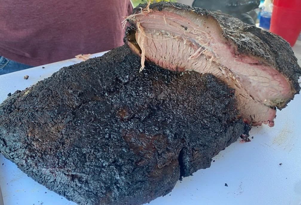 A finished brisket cut open to show the smoke ring and tender interior.