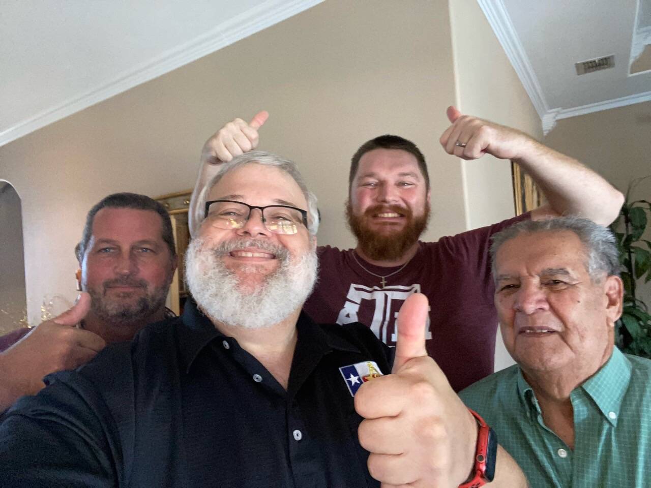 Four brothers of the lodge in a casual thumbs-up photograph — warm, approachable, and unguarded.