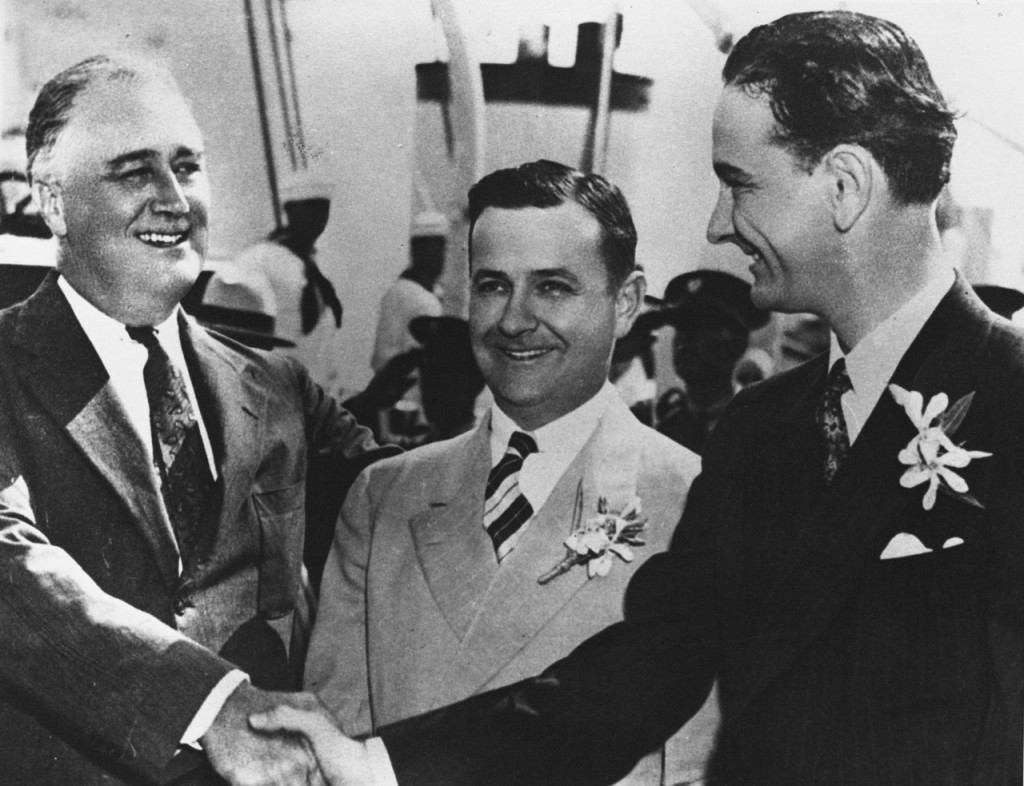 President Franklin D. Roosevelt shakes the hand of newly elected Congressman Lyndon B. Johnson in Galveston, Texas, May 12, 1937, with Governor James Allred between them.